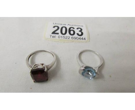 A silver ring set garnet, size N and a silver ring set topaz, size M.
