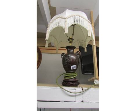 A bronze effect table lamp with shade.