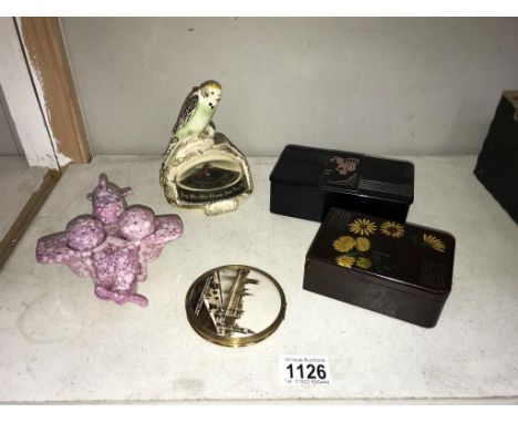 An Art deco 'budgie' barometer, Bakelite daisy box, French Bi-plane condiment set &amp; Houses of parliament compact.