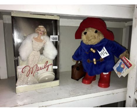 A boxed Mattel Marilyn Monroe collectors doll and a Paddington Bear