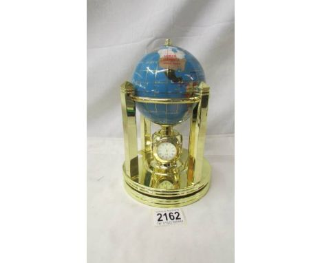 An Osborne &amp; Allen Ltd., revolving globe incorporating a 4 way clock, needs battery.