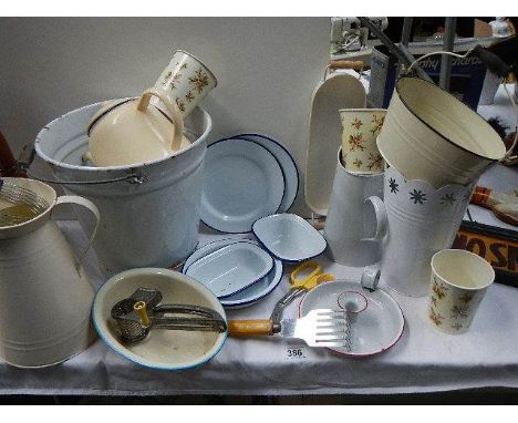 A mixed lot of vintage and modern enamel kitchen ware.