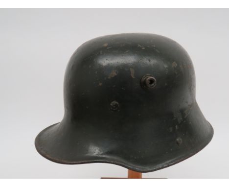 Imperial German M1916 Steel Helmetdark green crown of typical form with lower rolled brim.  Large side vent holes.  Internal 