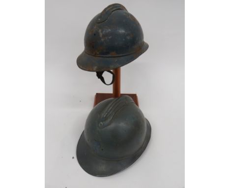 Two WW1 French Adrian Pattern Steel Helmetsblue painted crown.  Attached top comb.  Attached front peak and rear brim with si