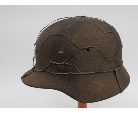 German Third Reich M1940 Zimmerit Camouflaged Steel Helmettwo tone, rough texture crown.  Applied chicken wire secured by fou