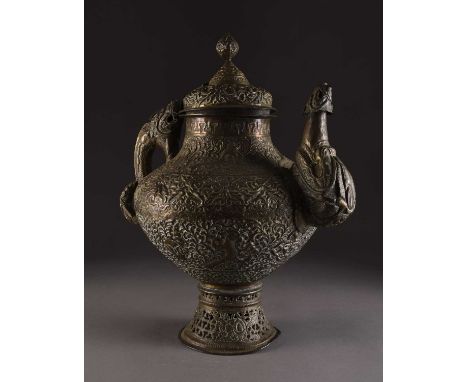 A Tibetan embossed copper teapot, 19th centuryOf onion form with domed cover, the handle and spout formed as mythical sea bea
