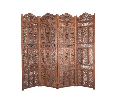 An Indian carved hardwood four-fold screen20th centuryEach panel with an arched top, carved and pierced with flowers and scro