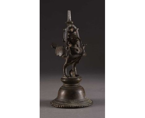 A Nepalese bronze figural temple bell, 19th centurySurmounted by a figure of the winged Garuda.22cm highProvenance:From the e