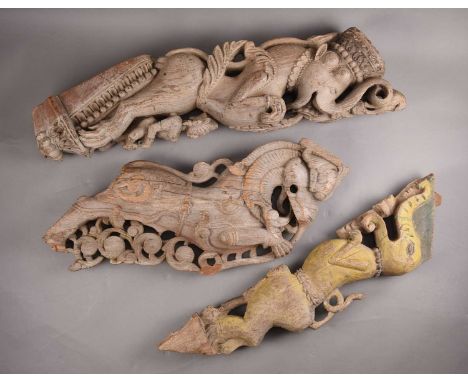 Three carved wooden corbels, Southern India19th century, each carved and painted as a stylised elephant.Largest 85cm highProv