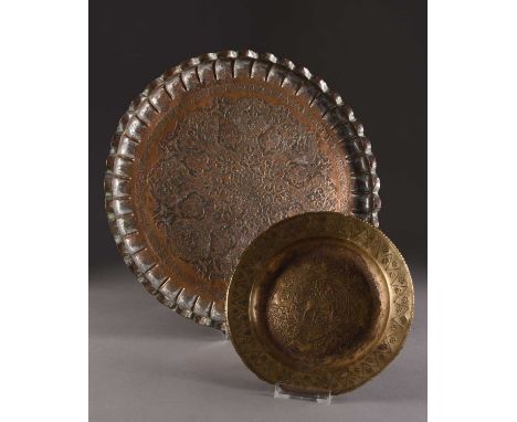A Persian tinned copper tray and an embossed dish, late 19th centuryThe tray with lobed rim and worked with repousse flowers 