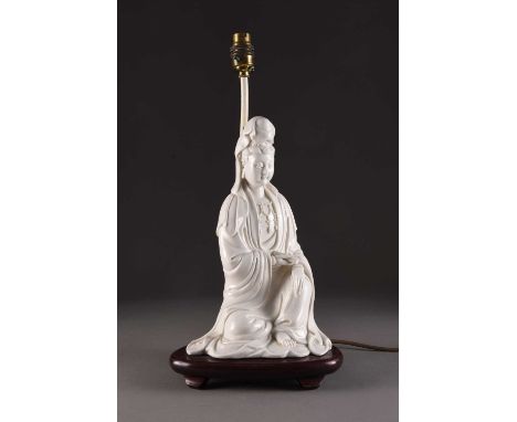 A Chinese blanc de chine figure of Guanyin, late Qing DynastyModelled seated and wearing flowing robes and a bead necklace, s