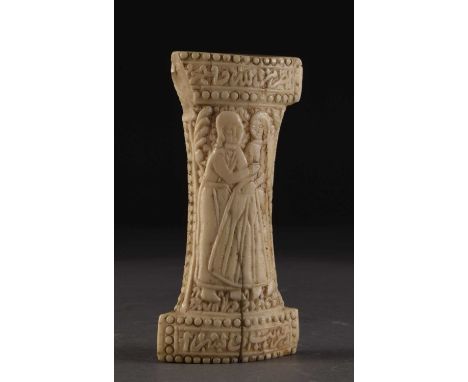 A Persian carved marine ivory khanjar hilt, 19th centuryWorked to each side with courting couples amid foliage, within beaded