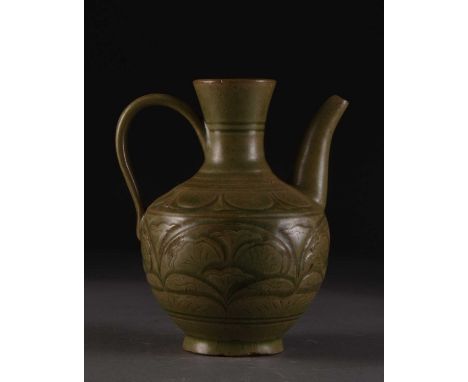 A Chinese Longquan celadon ewer, Yuan/Ming DynastyOf ovoid form with ribbed strap handle and tapering spout, the body carved 