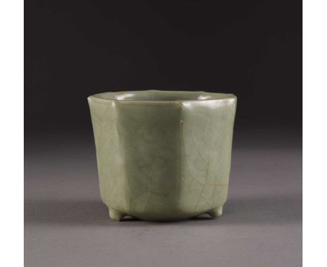 A Chinese Longquan celadon planter, Ming DynastyOf octagonal form and with three peg feet, each side incised with a stylised 