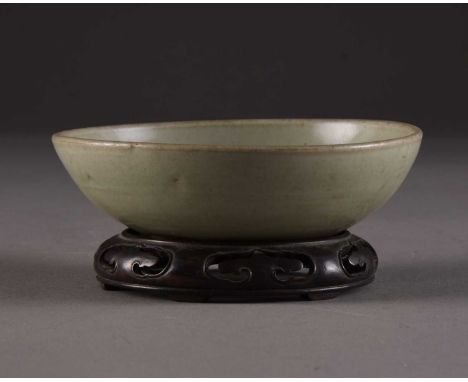 A Chinese Longquan brush washer, Yuan DynastyOf shallow coup form, incised to the inside centre with a lotus bloom, covered i