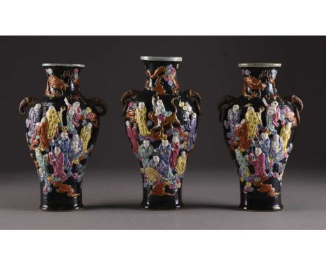 Three Chinese famille rose relief moulded vases Qianlong seal marks but likely 19th century Of ovoid form with twin elephant 