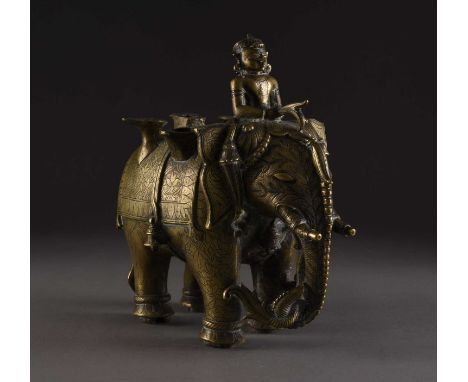 A silver inlaid bronze elephant, India, 18th/19th centuryModelled standing four square and bearing a leafy branch in its trun