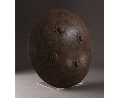 A Persian Damascened steel shield, Qajar Dynasty, 19th/20th centuryOf rounded form with four floret bosses, decorated with in
