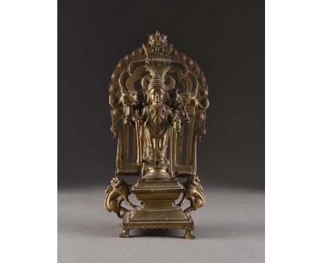 A bronze figure of Shiva, India, 19th centuryThe six-armed deity modelled standing in samapada on a circular base above a sha