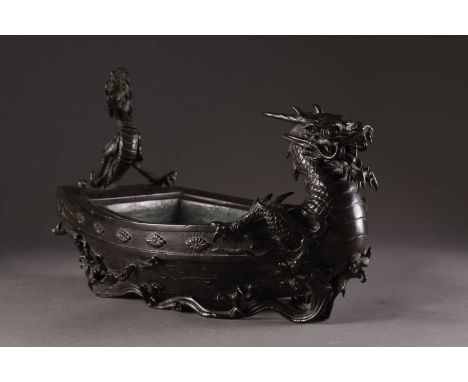 A Japanese bronze planter in the form of a ship, Meiji eraThe sides decorated with floret bosses, the prow and stern adorned 