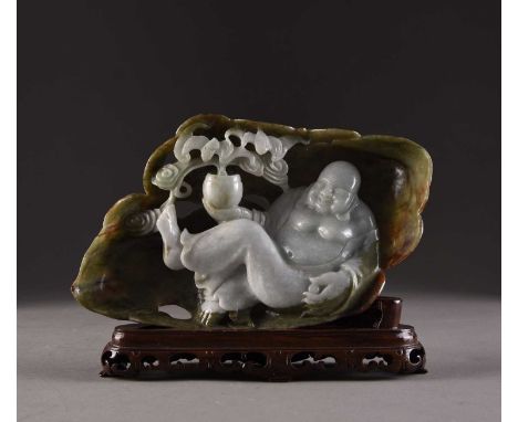 A Chinese jadeite boulder carving of Buddha, 20th centuryThe stone of graduated pale to dark green hue with ochre inclusions,
