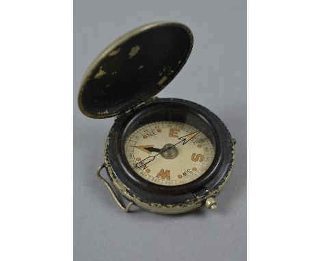 A SMALL WHITE METAL FLIP LID COMPASS, possibly WWI era and military issue, the case has two loops attached, which could have 