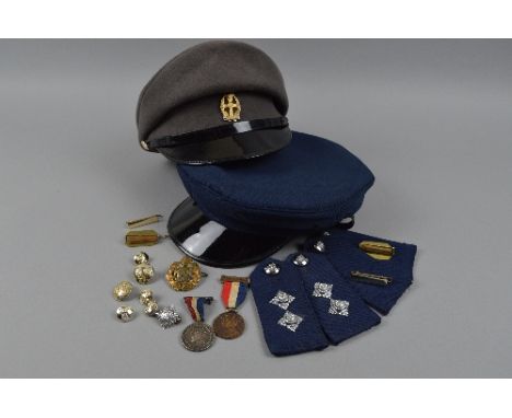 A BOX CONTAINING A QUEEN ALEXANDRA ROYAL ARMY NURSING CORPS CAP AND BADGE, a blue peaked cap by Westminster, believed to be p