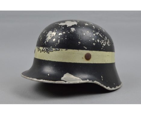 A WWI ERA GERMAN LIGHT WEIGHT METAL HELMET, possibly used by German fire/Police Service, the helmet is black but is missing l