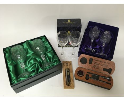 A box of modern wine glasses, a thermometer and a corkscrew.