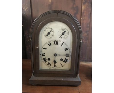 An arch topped mahogany cased alarm clock.