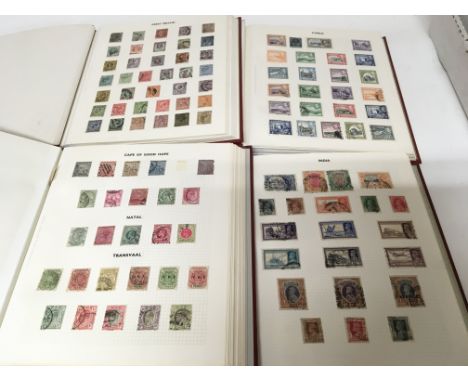 Four red stamp albums containing a good collection of world stamps Queen Victoria to Elizabeth II. Including some higher valu