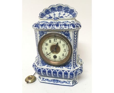 A Dutch delft clock fitted with a key wind mechanical movement. With pendulum Hight 24cm.