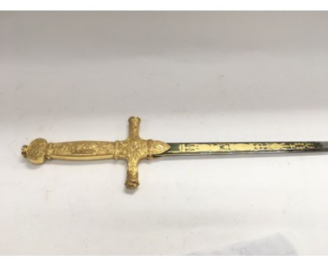 An ornamental sword with a finely decorated hilt in gilt brass and giltwork on the blade, no scabbard.