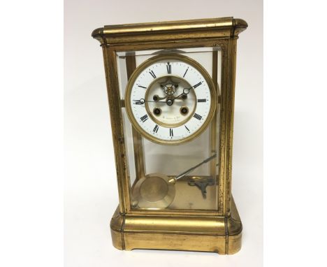 A gilt metal early 20th century four glass clock with an enamel dial maker W Lister &amp; Son with key and pendulum voidable 