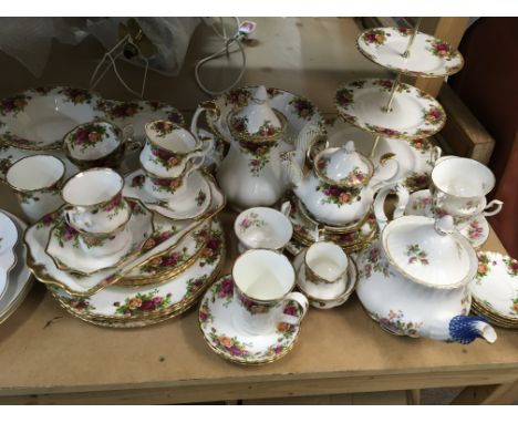 A collection of Royal Albert old English County Rose and some Moss Rose tea and dinner ware including tea and coffee pots a c