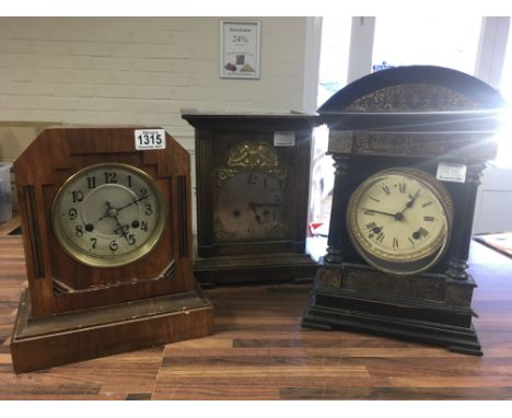 A Victorian ebonized mantle clock of classical influence, the circular dial with Roman numerals and two other mantle clocks