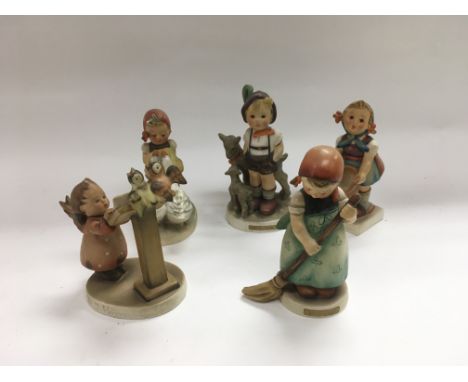 Five Goebel Hummel figures of children.