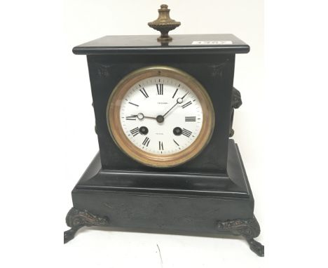 A Victorian black slate Mantel clock with a white enamel dial marked Osbank fitted with a French brass movement striking on a