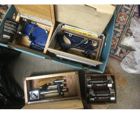 A quantity of work tools. These include a Bosch circular saw, a mitre cutter, a magnetic clock base, a dovetail template, a r