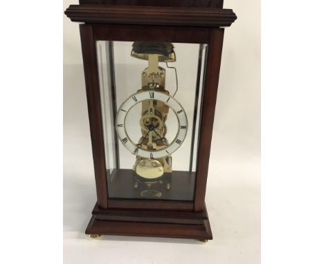 A Greenwich mantle clock with visible pendulum.