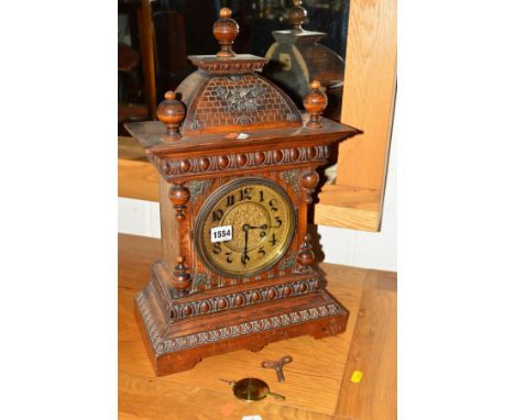 AN EARLY 20TH CENTURY CARVED OAK BRACKET CLOCK, marked to back and movement, J UNGHANS, brass dial with Arabic numerals, heig