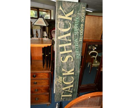 A LARGE DISTRESSED VINTAGE PAINTED SIGN, reading 'The Tack Shack, Equestrian Supplies', 244cm x 61cm