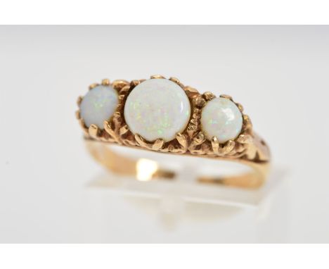 A 9CT GOLD THREE STONE OPAL RING, designed as three graduated circular opals, scrolling detail to the gallery, with 9ct hallm