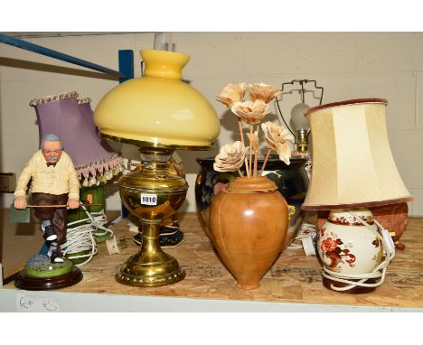 A BRASS BASED OIL LAMP WITH GLASS SHADE AND CHIMNEY, together with six various table lamps, a wooden vase and flowers, two pl