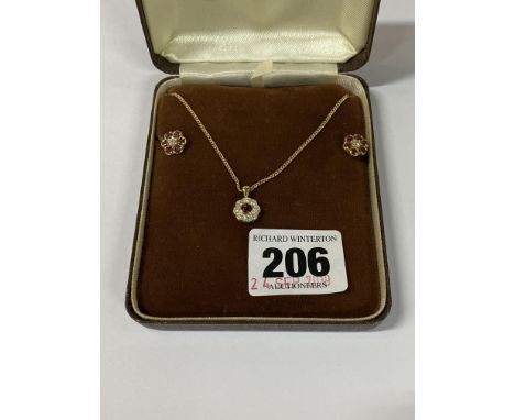 A MODERN 18CT GOLD RUBY AND DIAMOND PENDANT AND EARRING SET, circular clusters measuring approximately 10mm in diameter each,