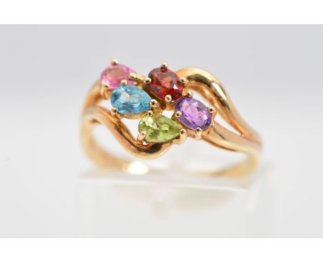 A 9CT GOLD MULTI-GEM RING, of a cross over style design centrally claw set with pear shape and oval shape gems, to include am