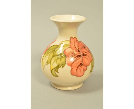 A SMALL MOORCROFT POTTERY VASE, 'Hibiscus' pattern on cream backgound, impressed and painted marks to base, height 13.5cm