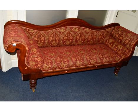 A VICTORIAN WALNUT TWO SEATER SOFA, with a wavy back and scrolled arms on baluster legs and brass casters, width 206cm 