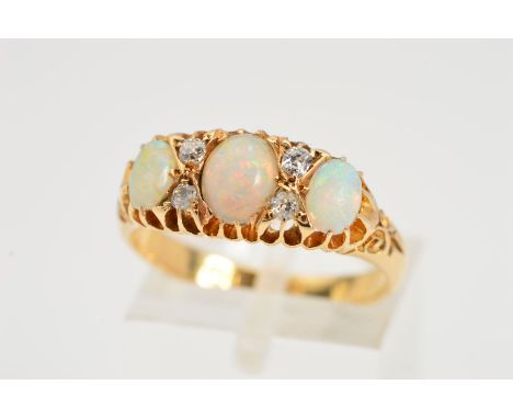 AN EDWARDIAN 18CT GOLD OPAL AND DIAMOND RING, designed as three graduated oval opal cabochons interspaced by four old cut dia