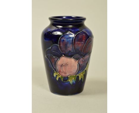 A SMALL MOORCROFT POTTERY VASE, 'Anemone' pattern on blue ground, impressed marks and label to base, height 9cm